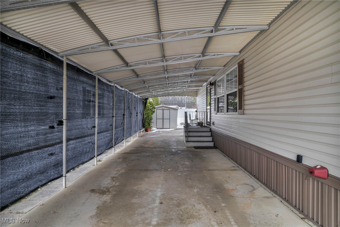 27202 Cook Road, Unit 95 Olmsted Falls, OH 44138 - Photo 6 of 46 View of vehicle parking with a shed