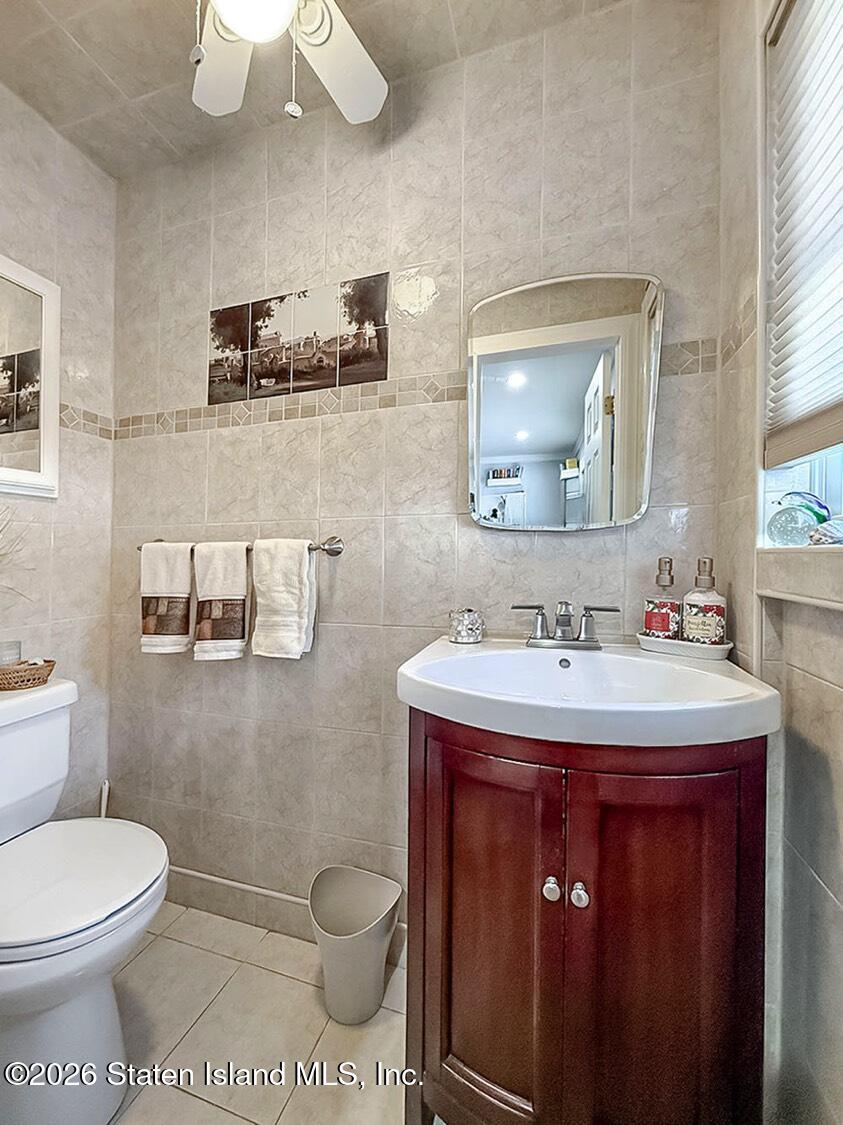 69 Stecher Street Staten Island, NY 10312 - Photo 13 of 45 a bathroom with a toilet a sink and mirror