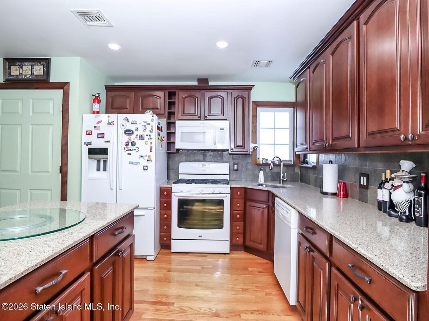 69 Stecher Street Staten Island, NY 10312 - Photo 24 of 45 a kitchen with stainless steel appliances granite countertop a refrigerator stove and sink