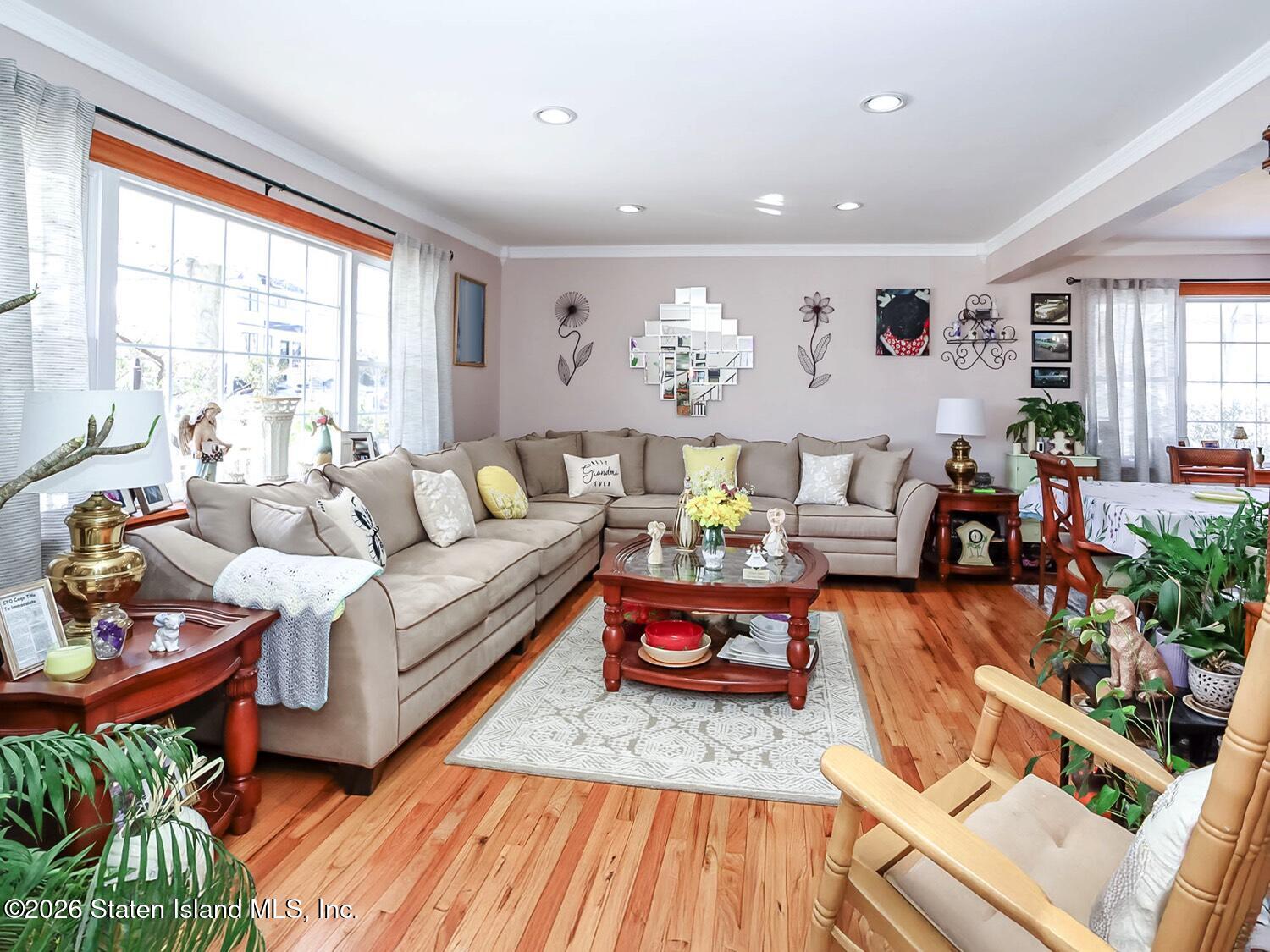 69 Stecher Street Staten Island, NY 10312 - Photo 4 of 45 a living room with furniture fireplace and a large window