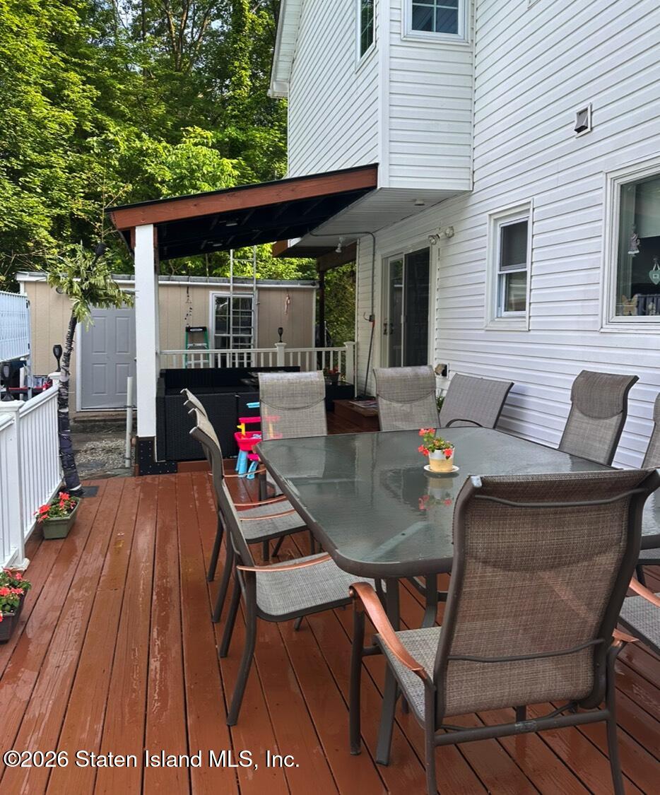 69 Stecher Street Staten Island, NY 10312 - Photo 41 of 45 a dining room with furniture and wooden floor