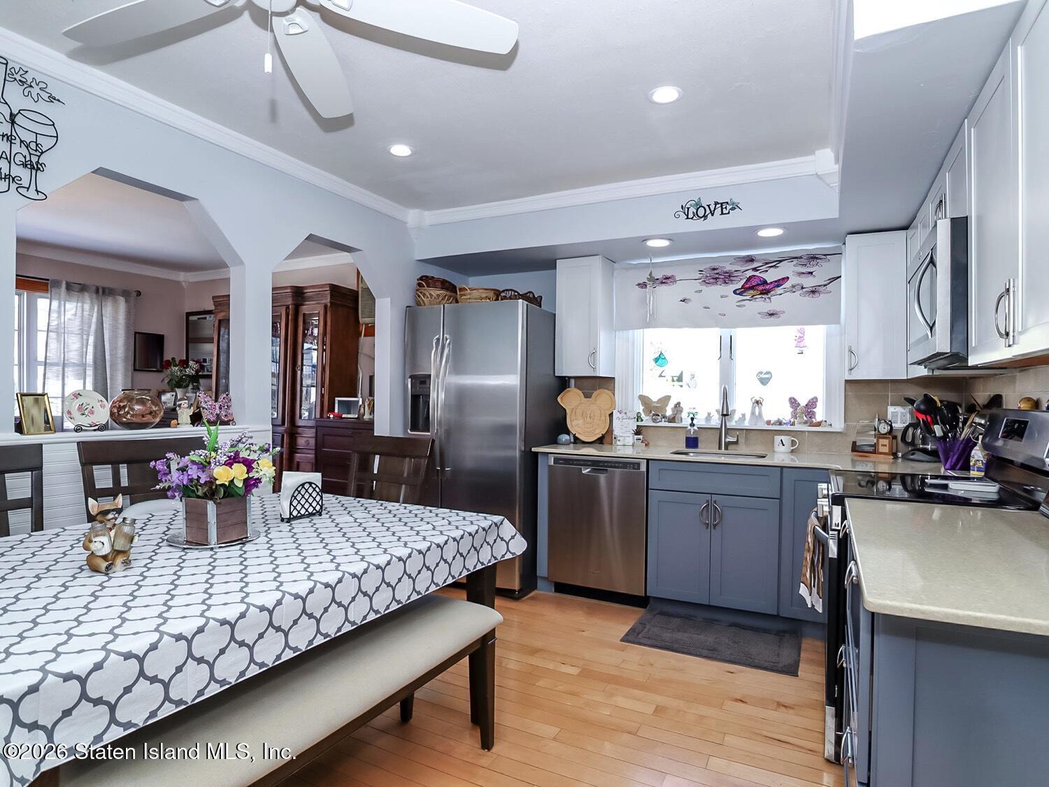 69 Stecher Street Staten Island, NY 10312 - Photo 8 of 45 a kitchen with sink cabinets dining table and chairs