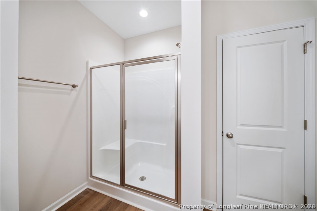 4044 Lofton Street Wade, NC 28395 - Photo 12 of 33 a bathroom with a glass shower door