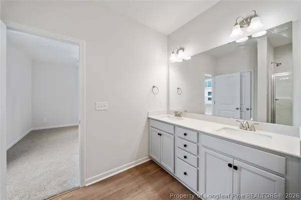 a bathroom with a double vanity sink and a mirror