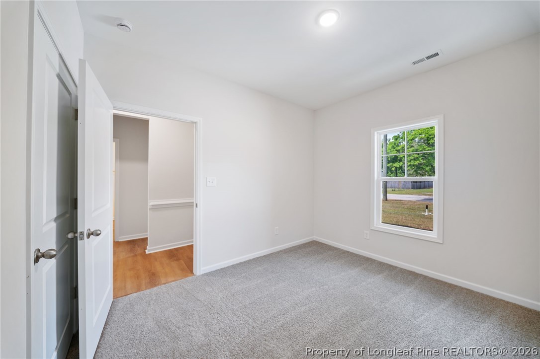 4044 Lofton Street Wade, NC 28395 - Photo 16 of 33 an empty room with windows