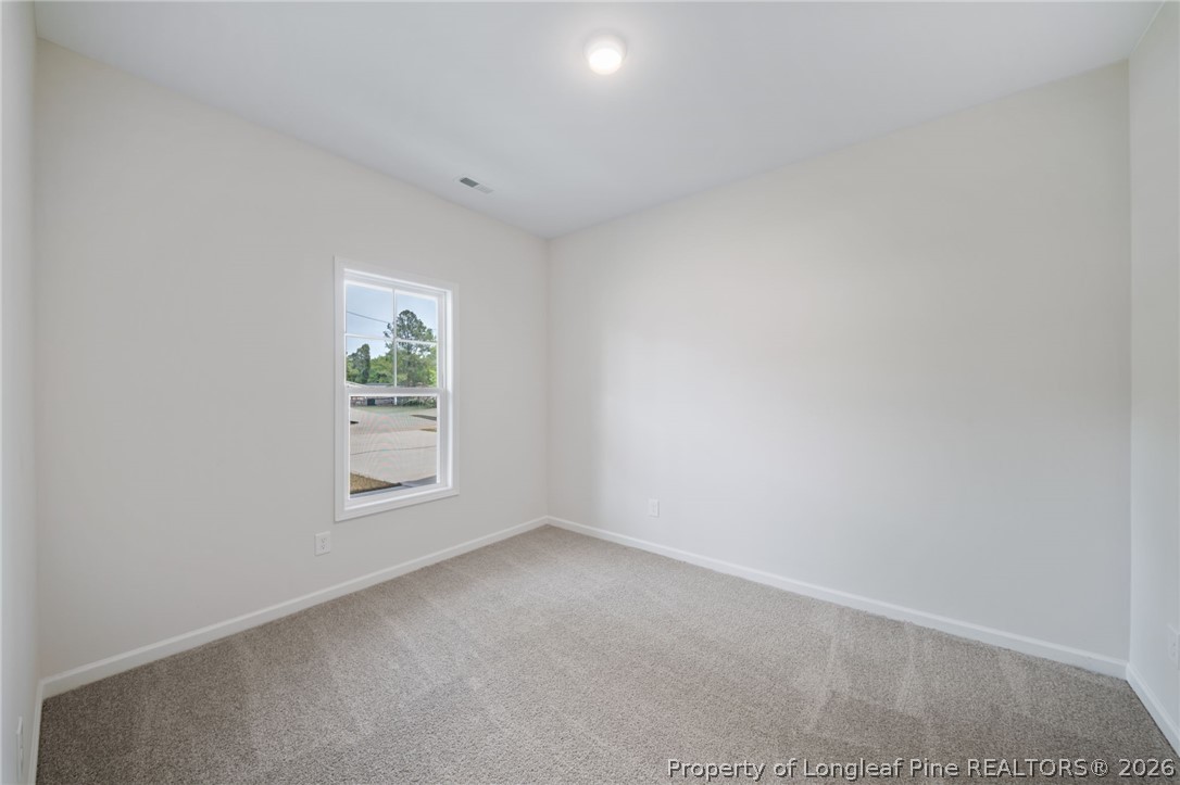 4044 Lofton Street Wade, NC 28395 - Photo 17 of 33 an empty room with windows