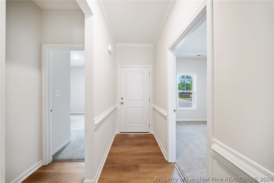 4044 Lofton Street Wade, NC 28395 - Photo 29 of 33 a view of a hallway with wooden floor and a bathroom