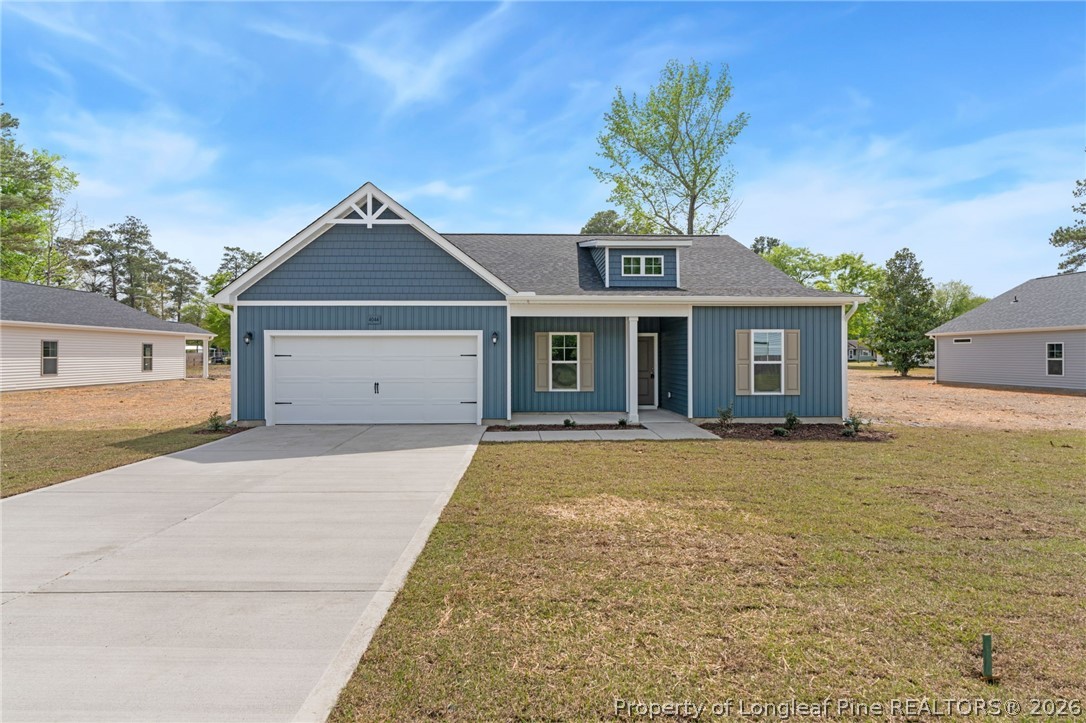 4044 Lofton Street Wade, NC 28395 - Photo 30 of 33 a front view of a house with a yard and garage