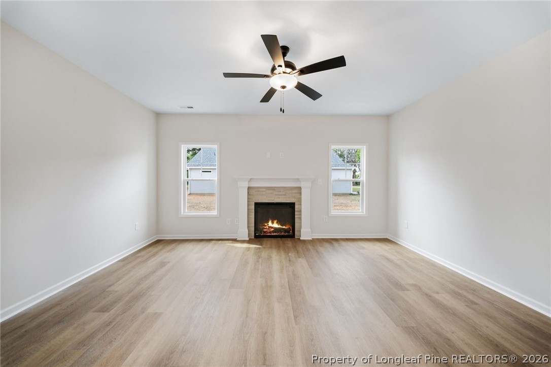 4044 Lofton Street Wade, NC 28395 - Photo 3 of 33 a view of an empty room with window and fireplace