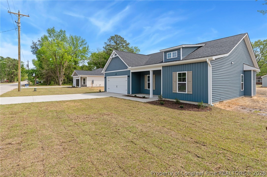 4044 Lofton Street Wade, NC 28395 - Photo 32 of 33 a view of a house with a yard and potted plants