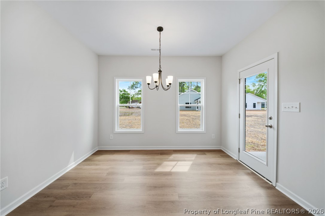 4044 Lofton Street Wade, NC 28395 - Photo 5 of 33 an empty room with windows and entrance