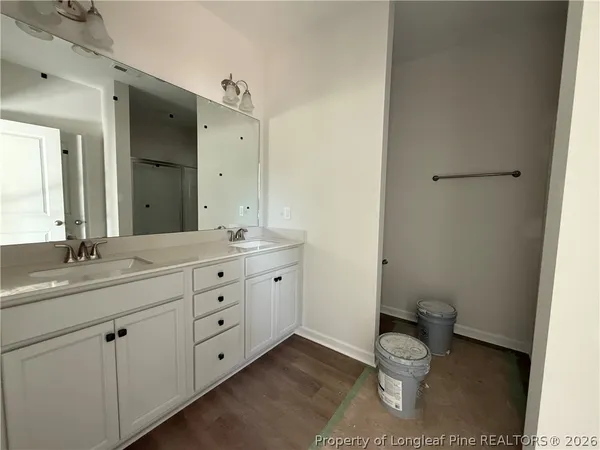 a bathroom with a granite countertop toilet a sink and a mirror