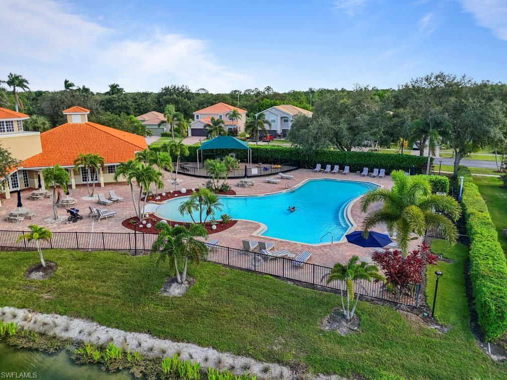 Undisclosed Address Naples, FL 34120 - Photo 21 of 24 Community pool featuring a patio