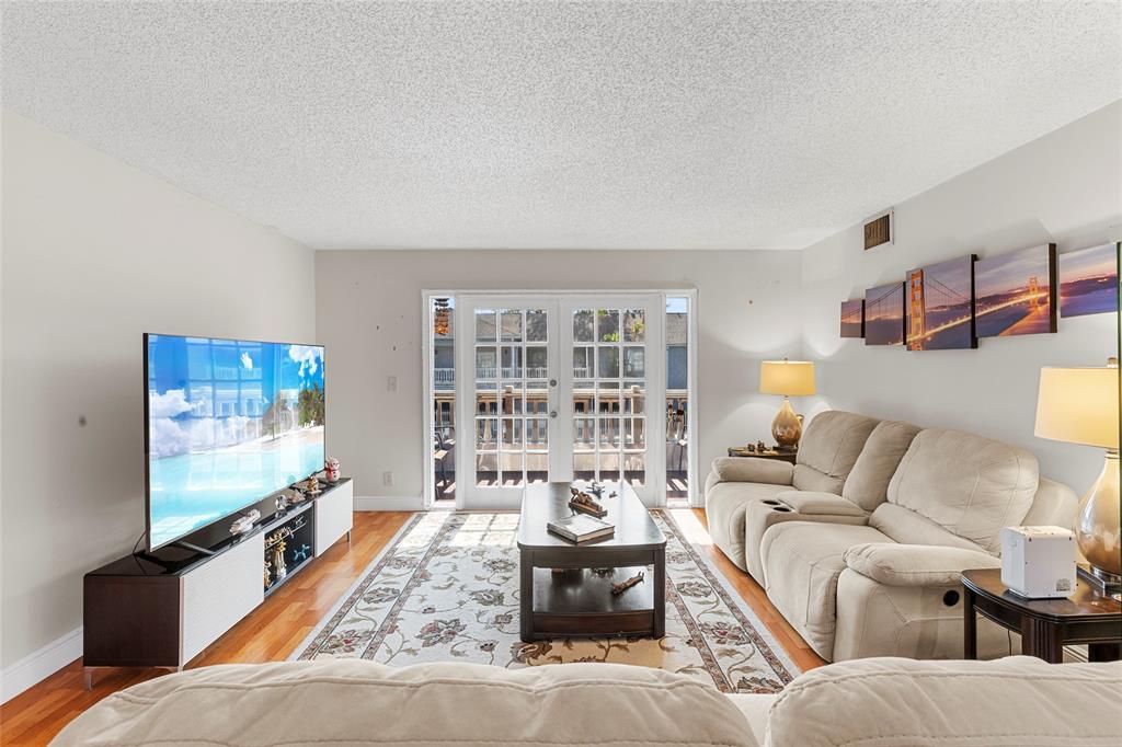7556 Stirling Road, Unit 222 Hollywood, FL 33024 - Photo 19 of 48 a living room with furniture and a flat screen tv