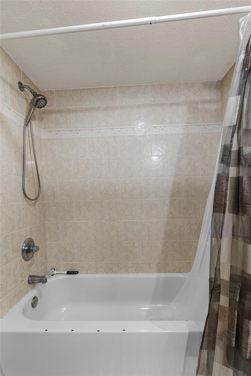 7556 Stirling Road, Unit 222 Hollywood, FL 33024 - Photo 22 of 48 a bathroom with a bath tub with a shower