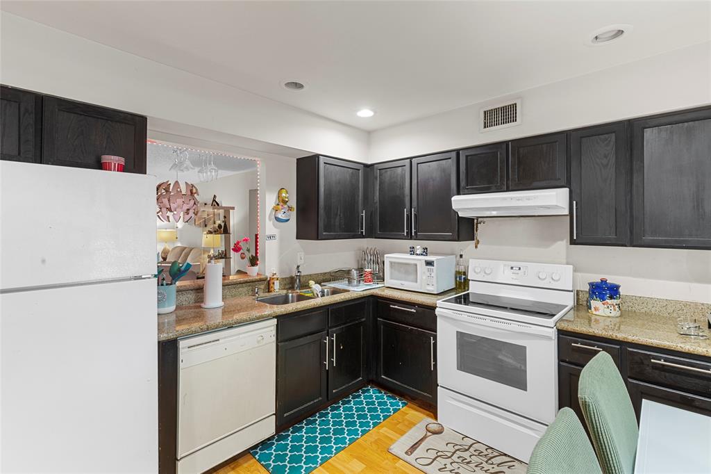 7556 Stirling Road, Unit 222 Hollywood, FL 33024 - Photo 27 of 48 a kitchen with a sink a stove and cabinets