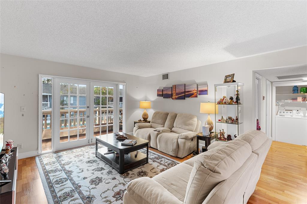 7556 Stirling Road, Unit 222 Hollywood, FL 33024 - Photo 28 of 48 a living room with furniture and a floor to ceiling window