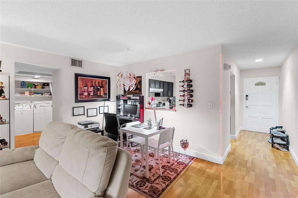 7556 Stirling Road, Unit 222 Hollywood, FL 33024 - Photo 29 of 48 a living room with furniture and a rug