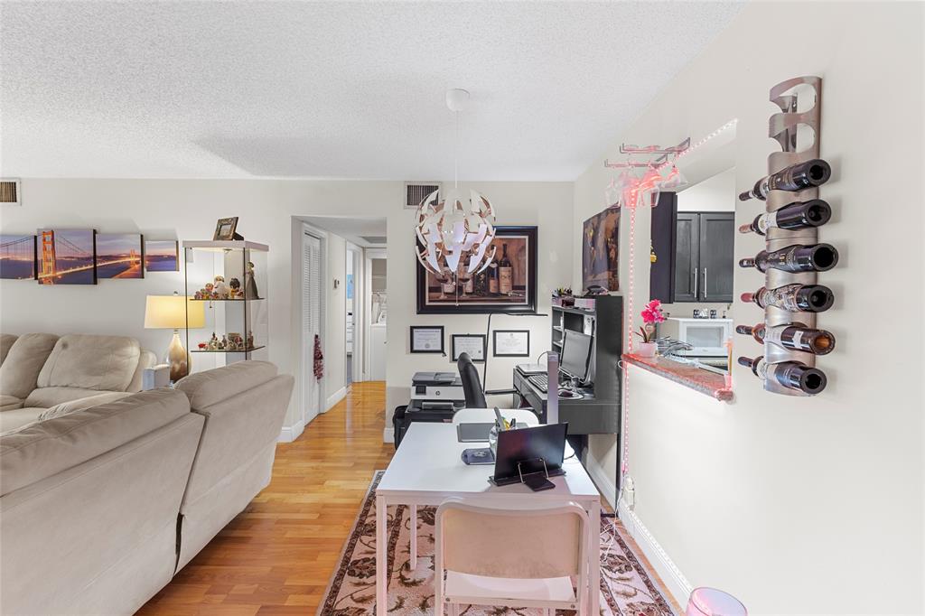 7556 Stirling Road, Unit 222 Hollywood, FL 33024 - Photo 30 of 48 a living room with furniture and wooden floor