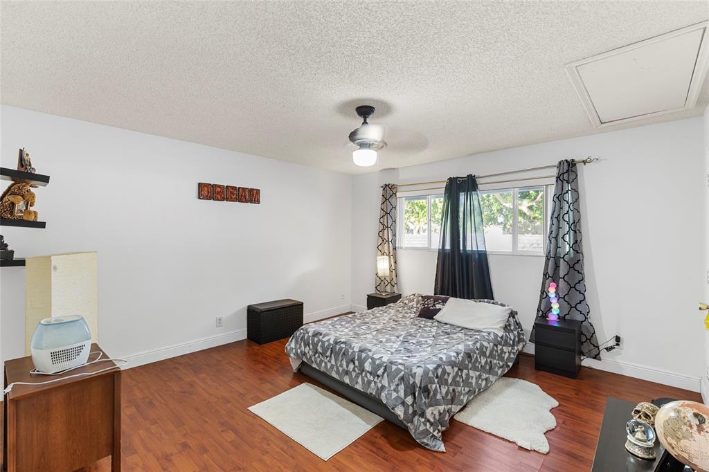 7556 Stirling Road, Unit 222 Hollywood, FL 33024 - Photo 7 of 48 a bedroom with a bed and a window