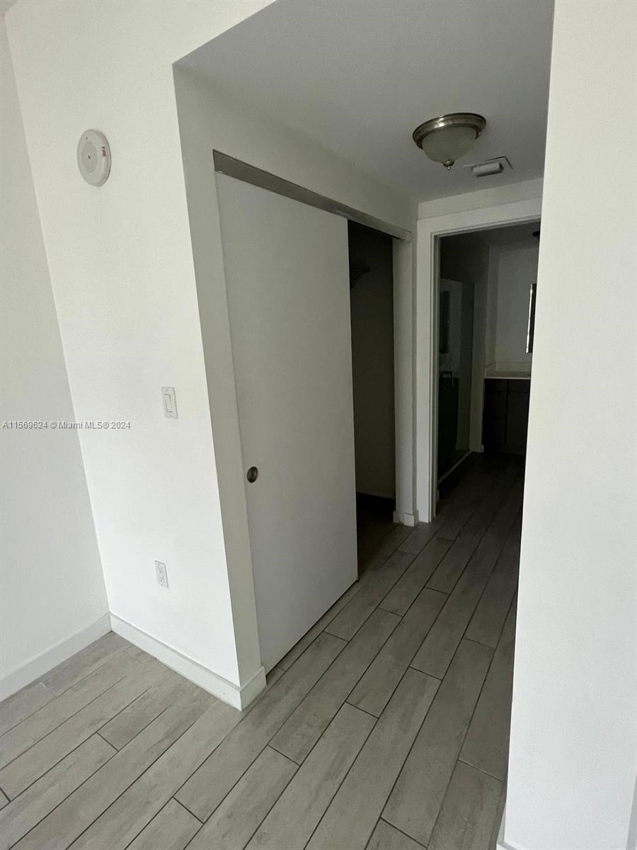 321 Northeast 26th Street, Unit 712 Miami, FL 33137 - Photo 6 of 8 a view of a hallway with wooden floor