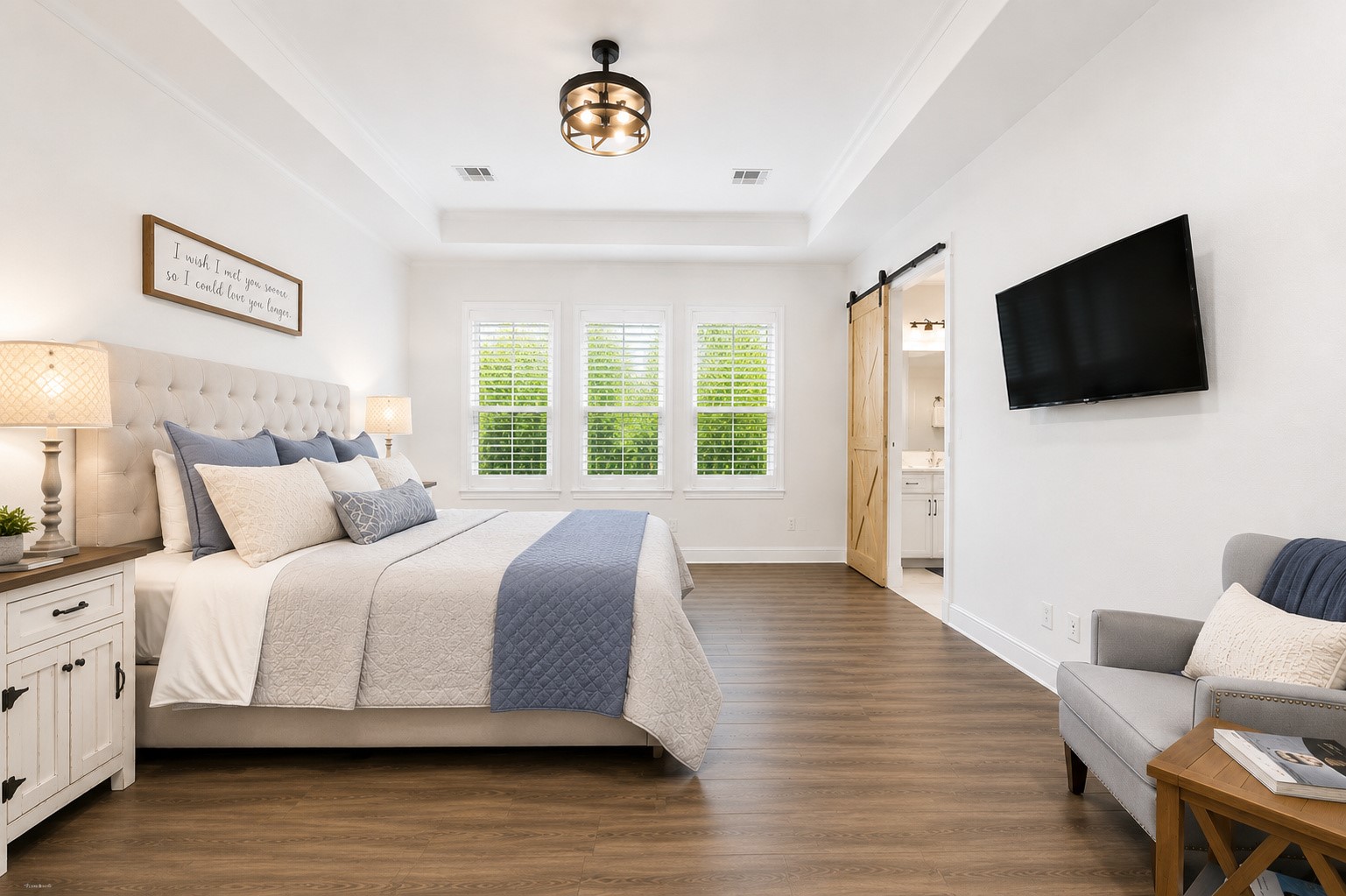 629 Germander Road Leander, TX 78641 - Photo 15 of 38 a spacious bedroom with a bed and a flat screen tv