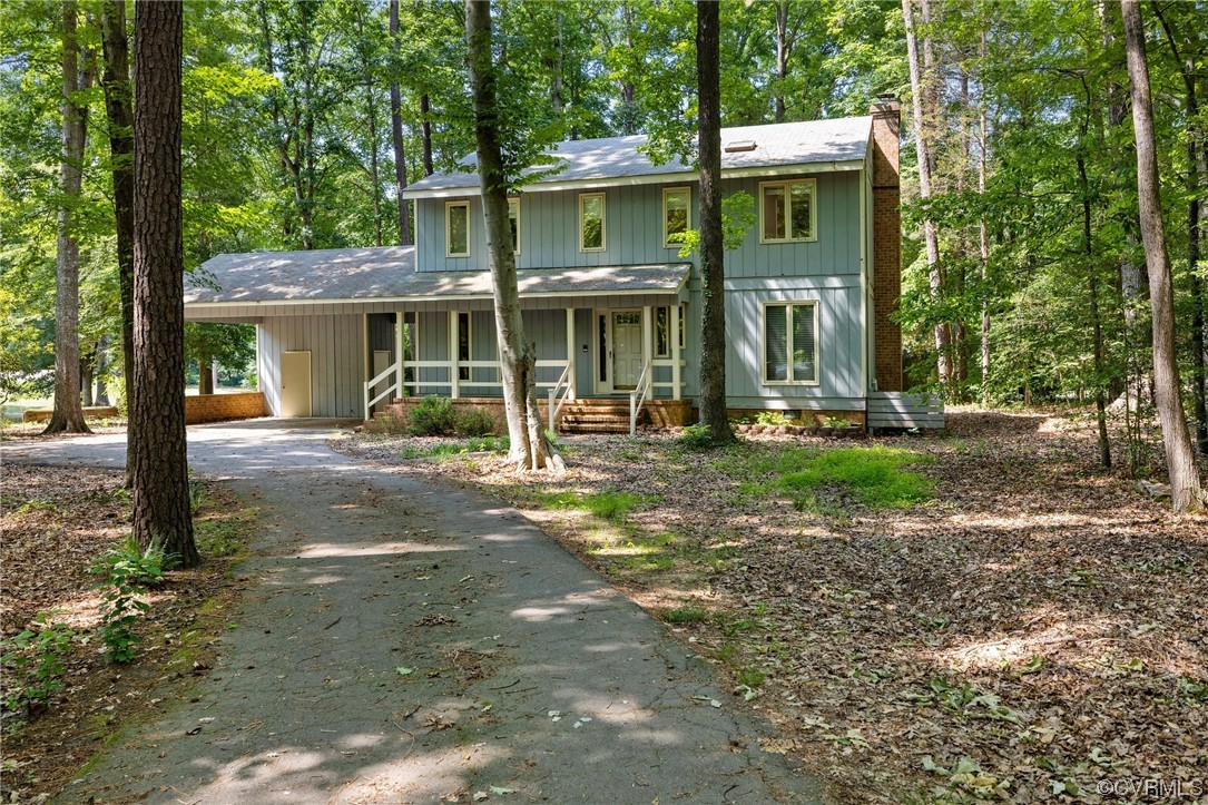 3828 Timber Ridge Road Midlothian, VA 23112 - Photo 2 of 34 a front view of a house with garden