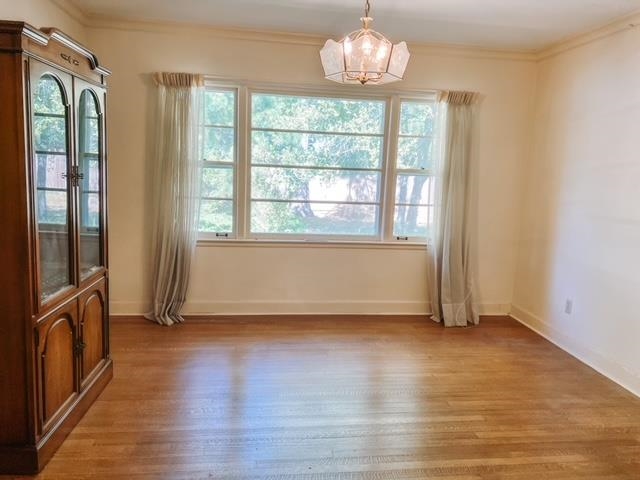 5208 Gwynne Road Memphis, TN 38117 - Photo 6 of 12 an empty room with wooden floor and windows