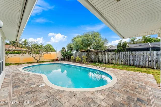an aerial view of a house with a swimming pool yard and outdoor seating