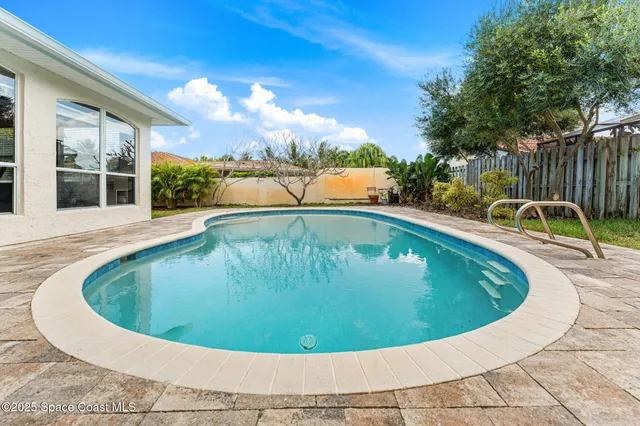 an aerial view of a house with yard swimming pool and outdoor seating