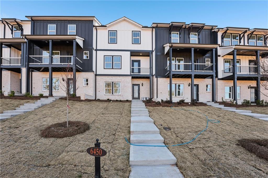 a front view of a residential apartment building with a yard