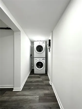 a view of a hallway with wooden floor and closet