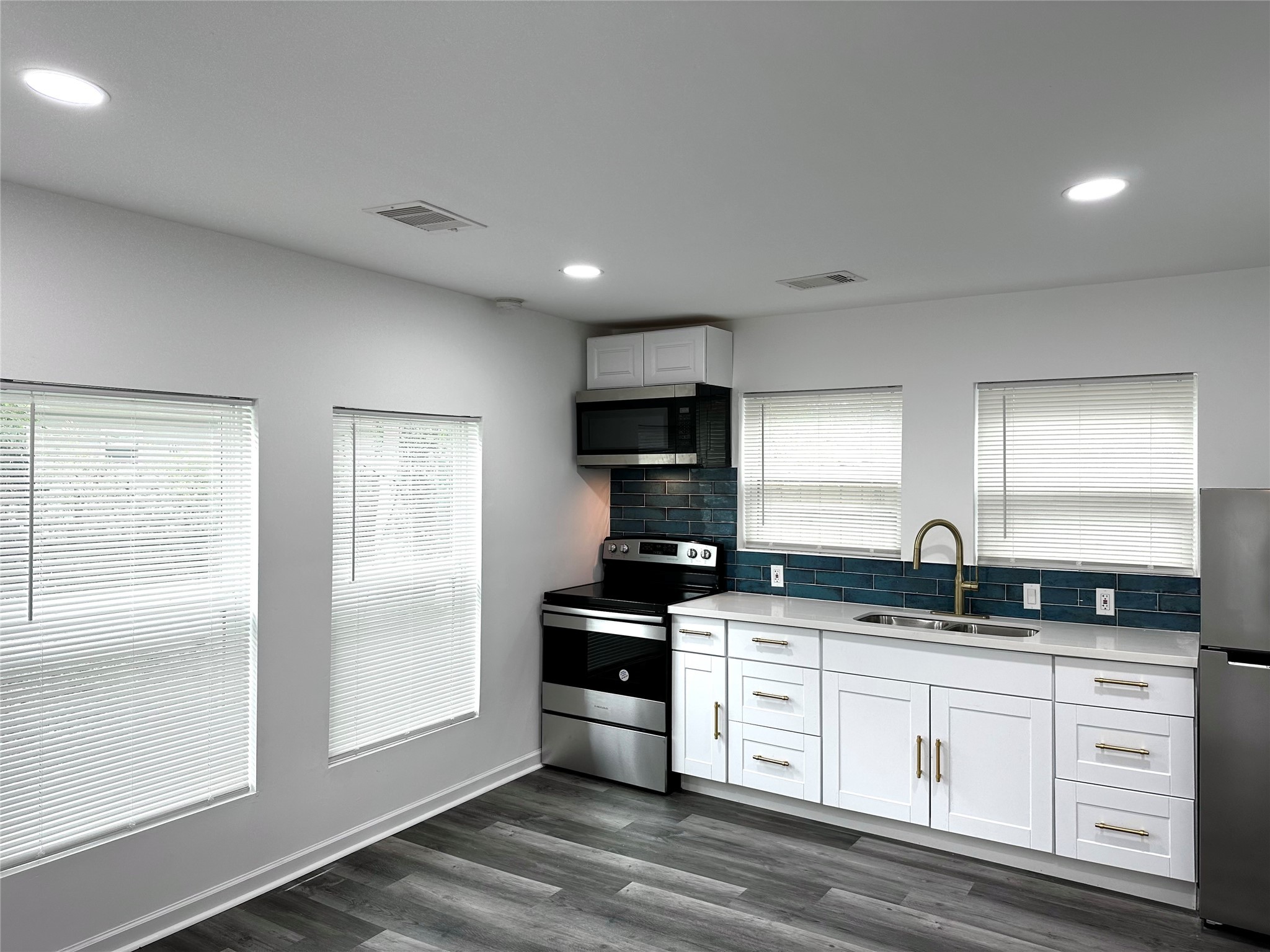 4318 1st Street, Unit C Bacliff, TX 77518 - Photo 5 of 14 a kitchen with granite countertop a sink and cabinets