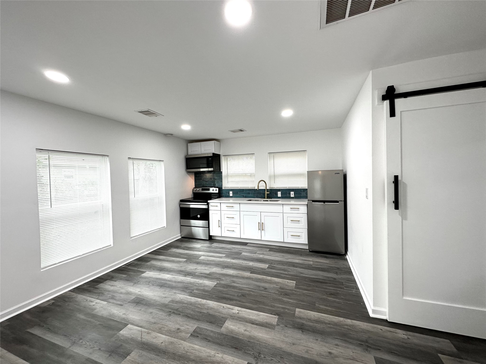 4318 1st Street, Unit C Bacliff, TX 77518 - Photo 6 of 14 a kitchen with refrigerator and cabinets