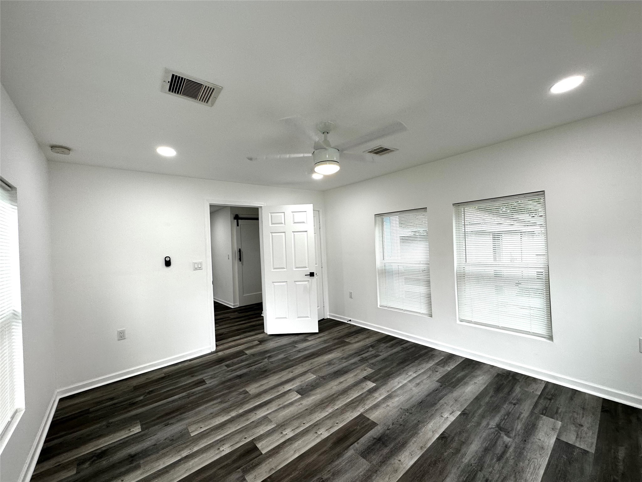 4318 1st Street, Unit C Bacliff, TX 77518 - Photo 8 of 14 a view of an empty room with wooden floor and a window