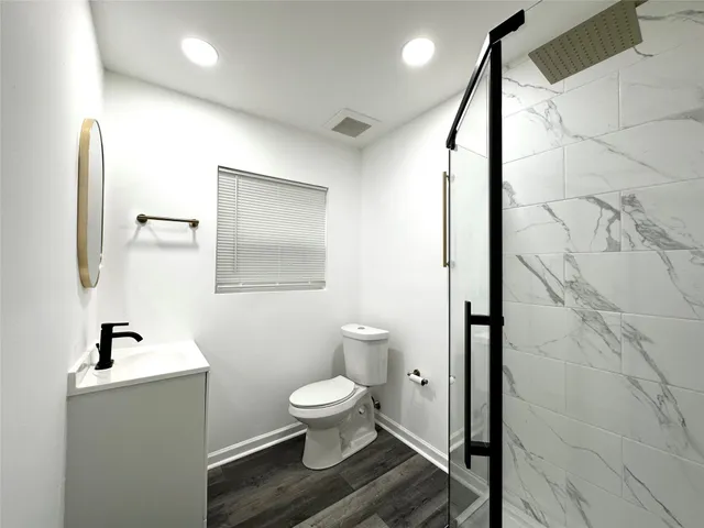 a bathroom with a toilet sink and mirror