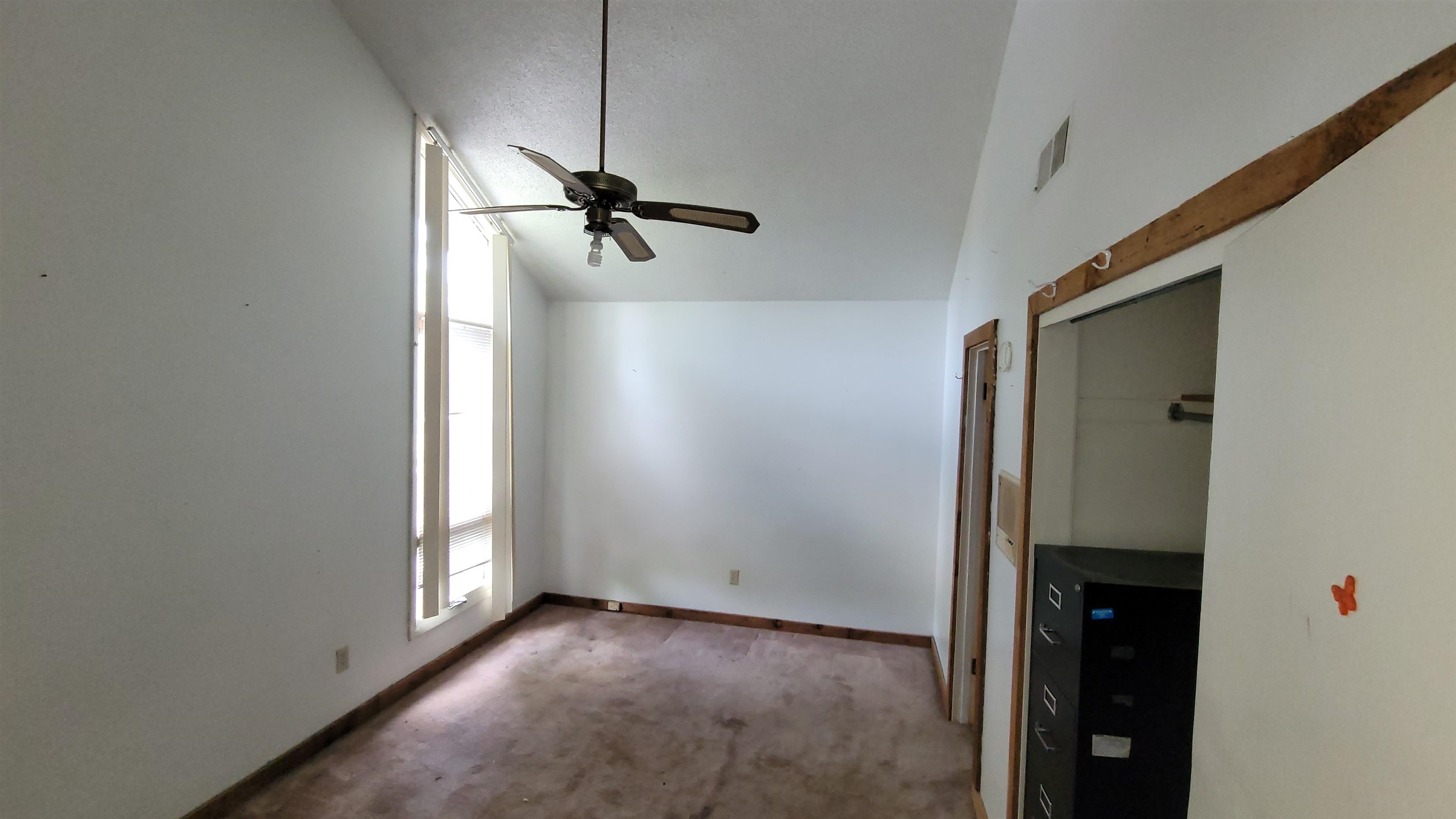 5258 Knight Arnold Road Memphis, TN 38118 - Photo 11 of 13 Unfurnished bedroom featuring baseboards, a ceiling fan, carpet floors, visible vents, and lofted ceiling