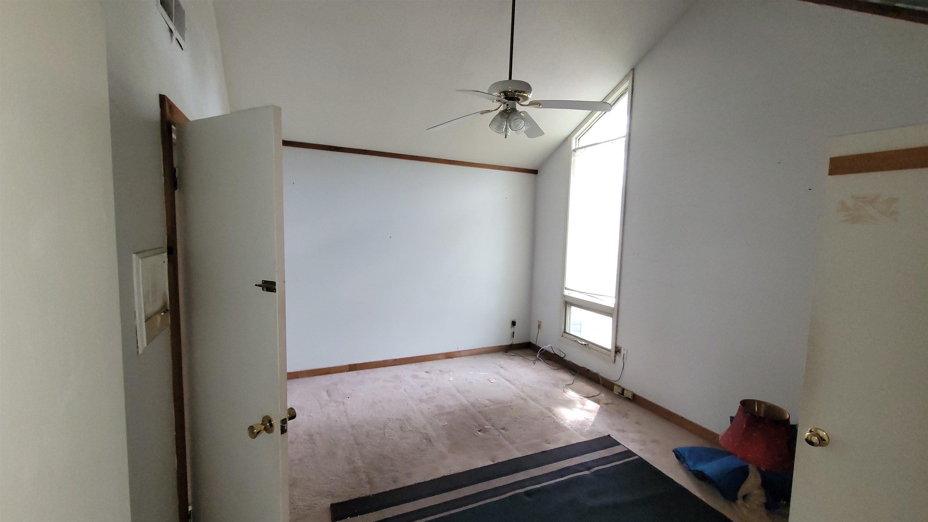 5258 Knight Arnold Road Memphis, TN 38118 - Photo 12 of 13 Empty room featuring baseboards, vaulted ceiling, and ceiling fan