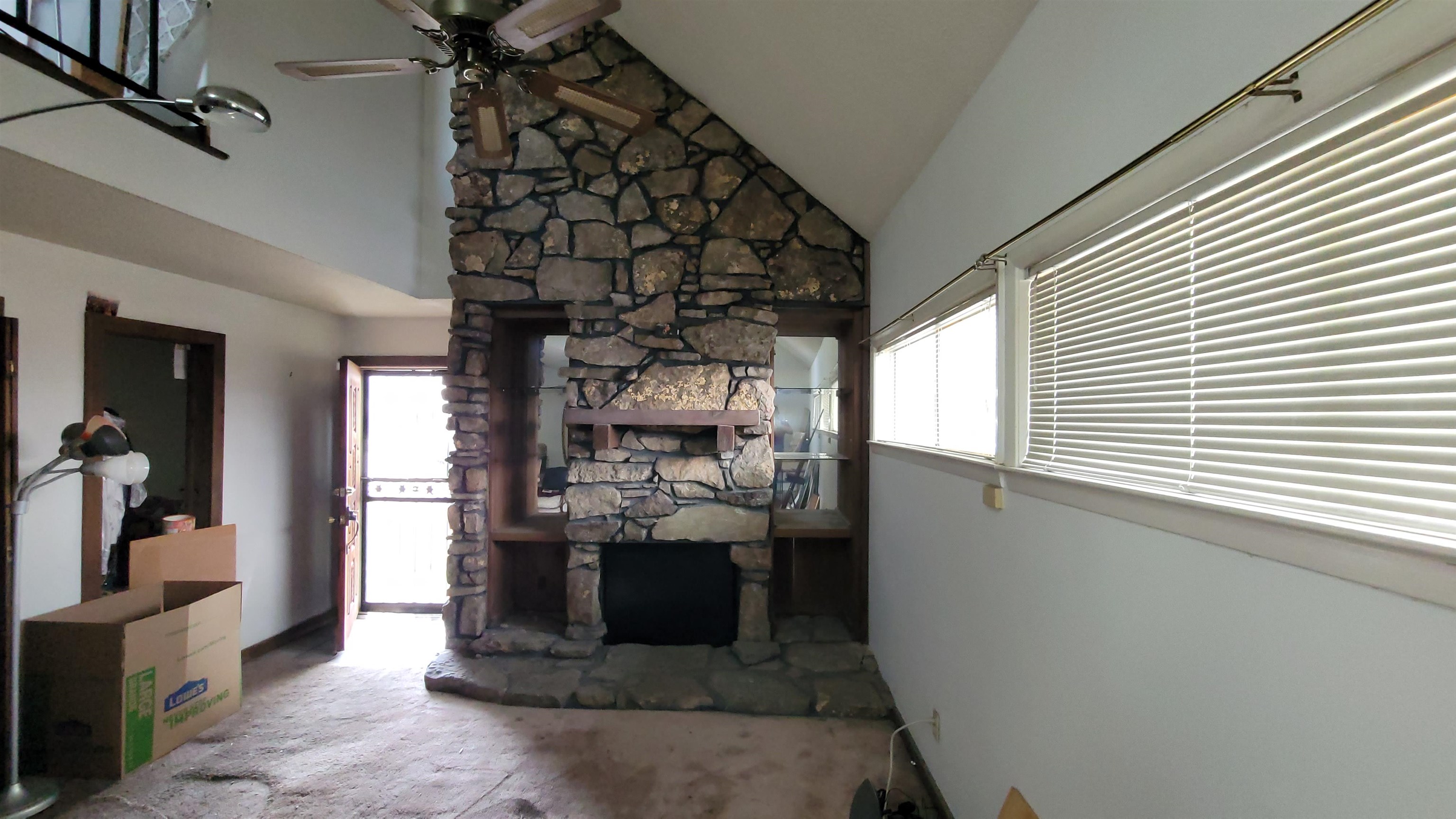 5258 Knight Arnold Road Memphis, TN 38118 - Photo 5 of 13 Unfurnished living room with high vaulted ceiling, ceiling fan, and a fireplace
