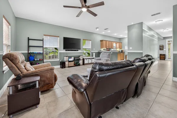 a living room with furniture and kitchen view