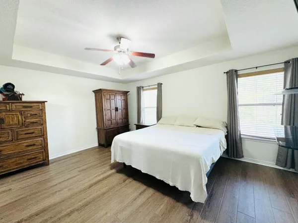 a bedroom with double bed and a chandelier