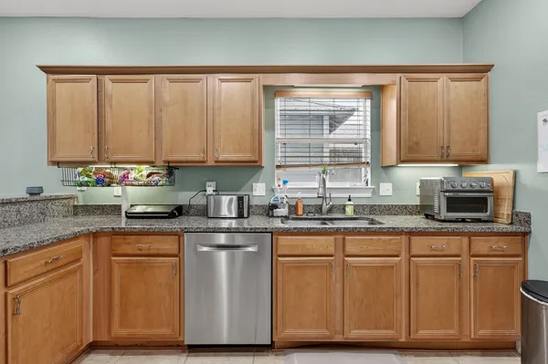 a kitchen with appliances a refrigerator and cabinets