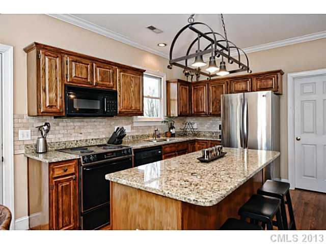 7603 Rathlin Court Charlotte, NC 28270 - Photo 6 of 15 a kitchen with stainless steel appliances granite countertop a sink stove and refrigerator