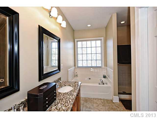 7603 Rathlin Court Charlotte, NC 28270 - Photo 9 of 15 a bathroom with a bathtub sink and mirror