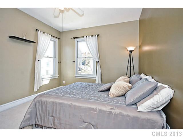 7603 Rathlin Court Charlotte, NC 28270 - Photo 10 of 15 a bedroom with a bed and a chandelier