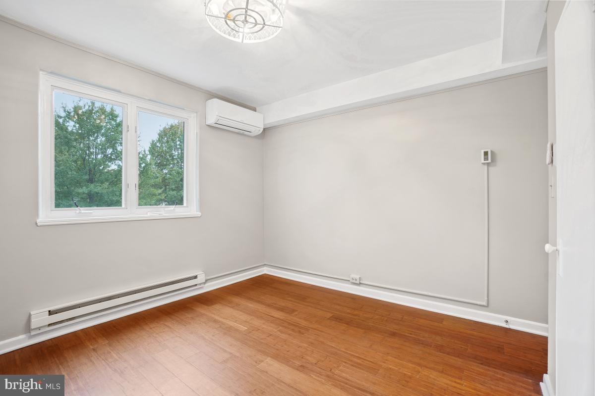 33 Ridge Road Greenbelt, MD 20770 - Photo 17 of 29 a view of a room with wooden floor and window