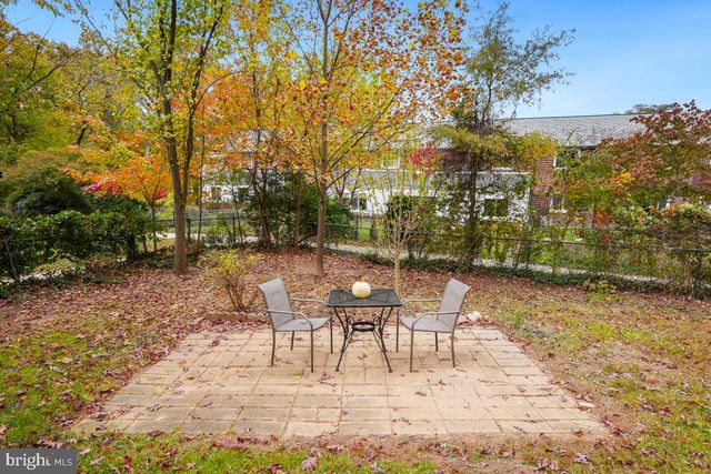 a view of a patio with a table and chairs