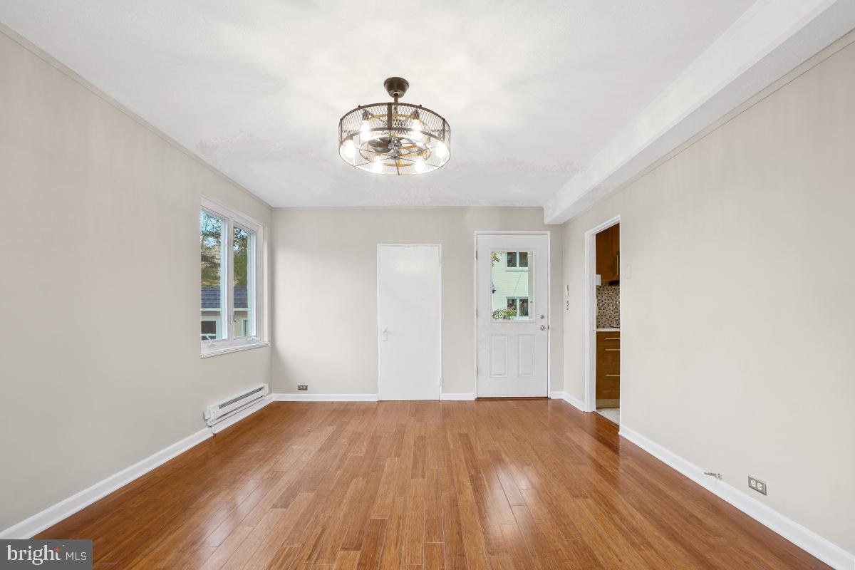 33 Ridge Road Greenbelt, MD 20770 - Photo 6 of 29 a view of a room with wooden floor and chandelier