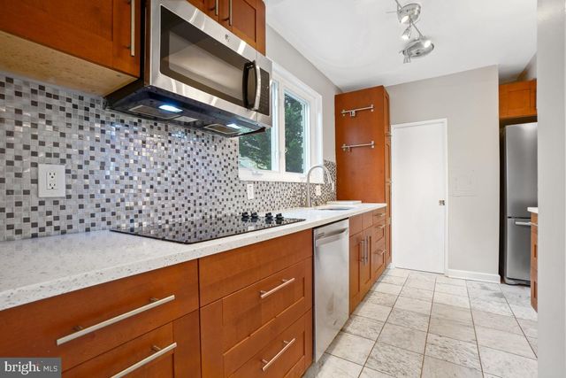 a kitchen with a sink a counter top space and cabinets