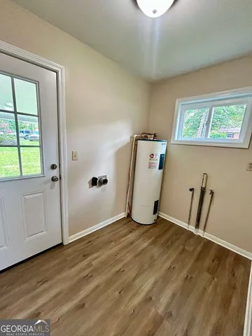 a view of a room with wooden floor
